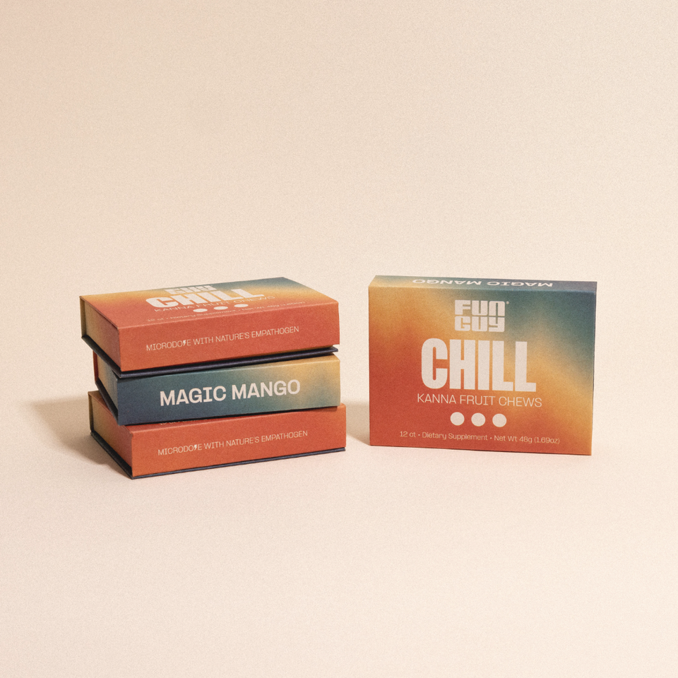 Three vibrant boxes of Fun Guy Chill Fruit Chews in Magic Mango flavor are shown. Featuring an orange-blue gradient design, these chews promote stress relief with the tagline “Microdose With Nature’s Emanthogen.”.