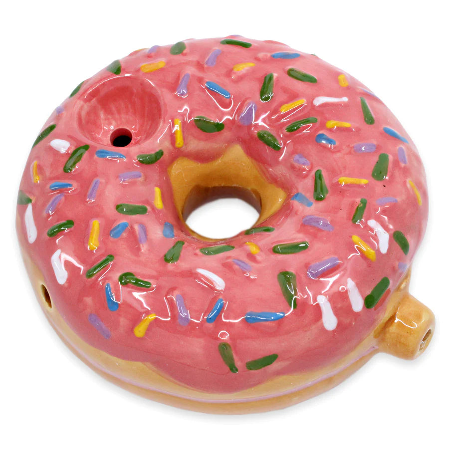 The Fashioncraft Donut Pipe is a ceramic novelty shaped like a donut with pink frosting and sprinkles, featuring a mouthpiece and bowl—perfect as a quirky 420 gift.