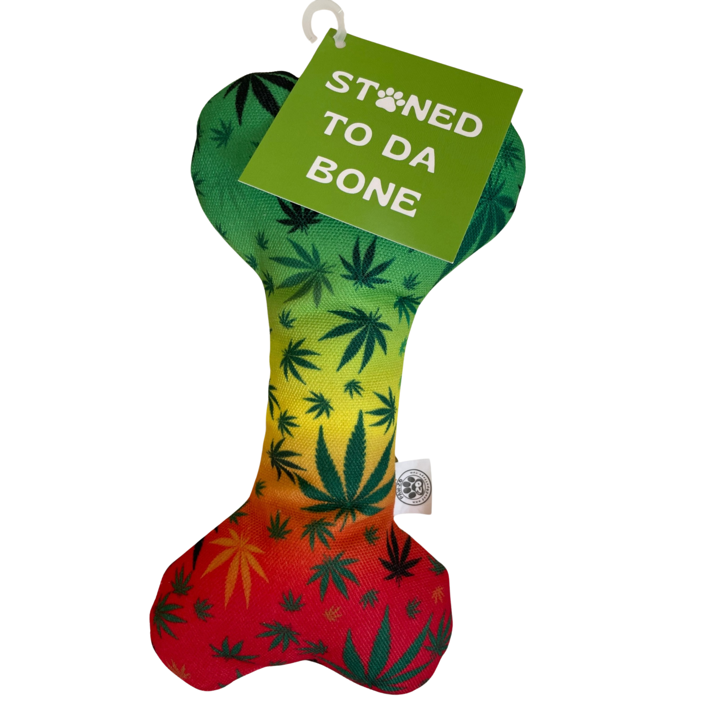The PAW:20 Stoned to da Bone Canvas Squeaky Toy is a bone-shaped dog toy with a green, yellow, and red gradient and marijuana leaf patterns. It features a green tag reading STONED TO DA BONE, with a paw print as the O in BONE.