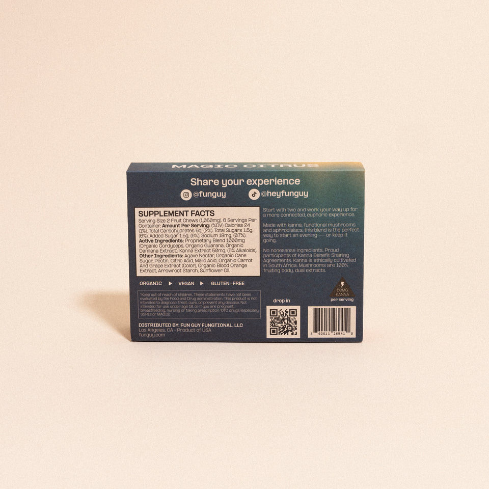 A box of Fun Guy Flow Fruit Chews is shown from the back, featuring supplement facts, social media handles, a QR code, and labels for organic, vegan, and gluten-free. The box rests on a neutral surface.