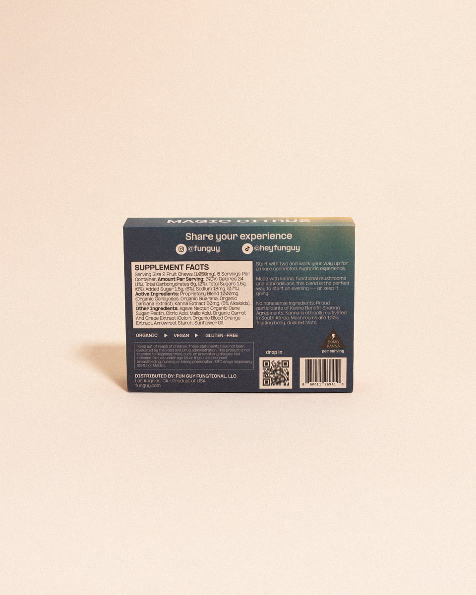 A box of Fun Guy Flow Fruit Chews is shown from the back, featuring supplement facts, social media handles, a QR code, and labels for organic, vegan, and gluten-free. The box rests on a neutral surface.