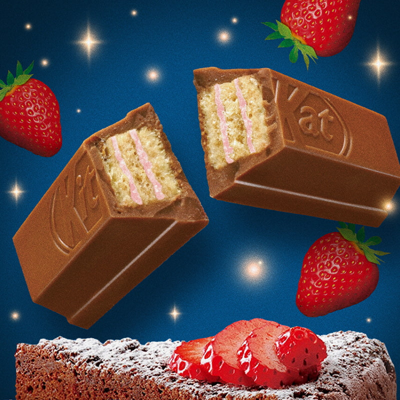 Exotic Snacks Kit Kat Strawberry Gateau Chocolate bars with pink and cream filling float among strawberries and stars on a blue background. Below, a powdered sugar brownie topped with strawberry chocolate is shown.