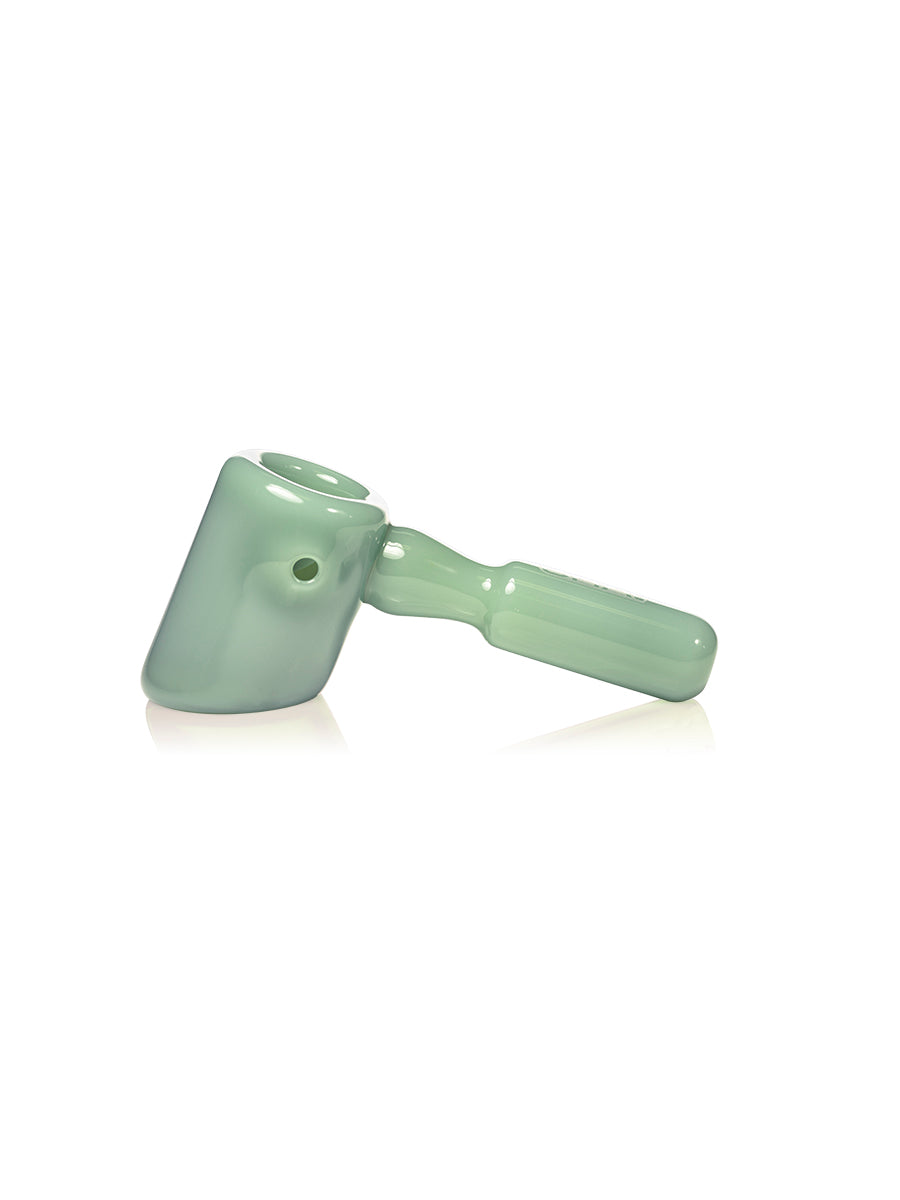 The GRAV Hammer Hand Pipe in light green features a cylindrical bowl, curved handle, and flat base, displayed on a white background.