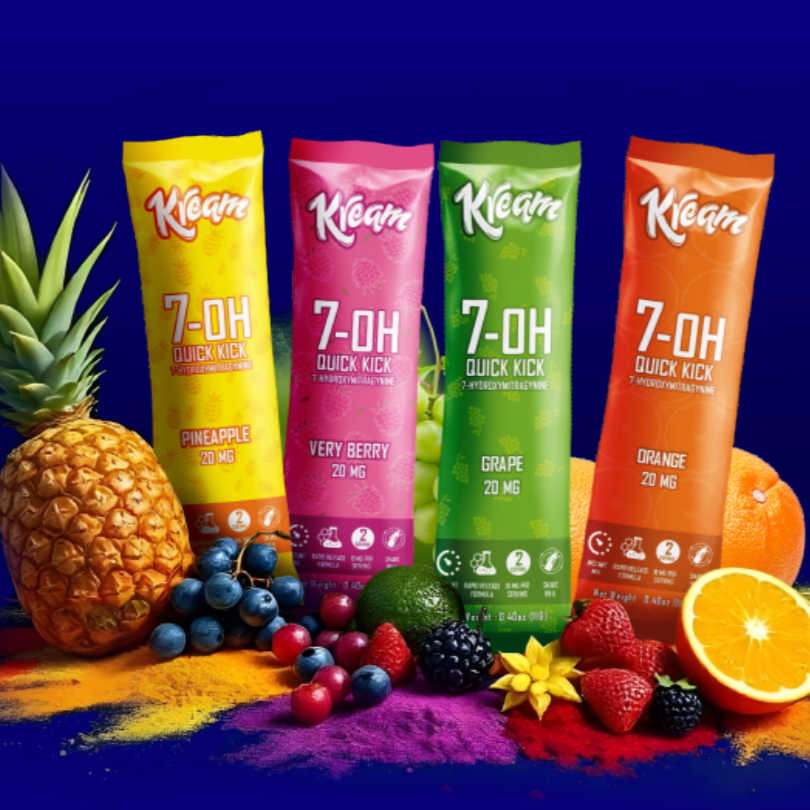 Four vibrant Quick Kick Kratom Powder packets from Kream—pineapple, very berry, grape, and orange—are displayed with fresh fruits and powders on a blue background, each delivering fast-acting energy with 7-Hydroxymitragynine.