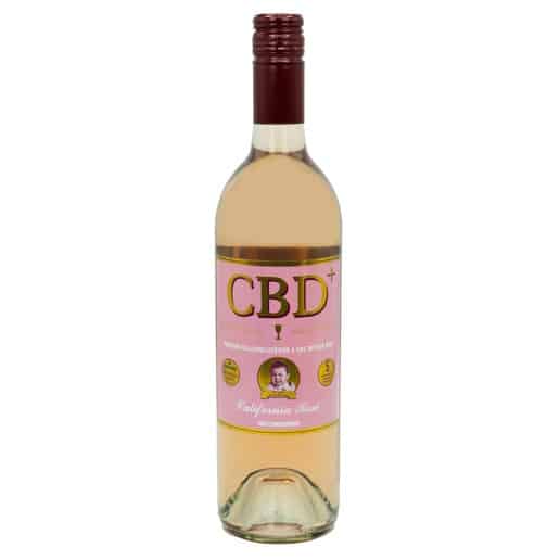 A bottle of Cry Baby Wine CBD Rosè, featuring a pink CBD+ label with a small portrait, gold medals, California Rosé text, and finished with a maroon screw cap.