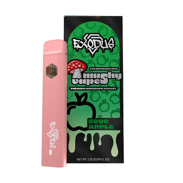 A pink Exodus Mushy Vape disposable pen stands beside its packaging, which displays green drips, apples, and mushrooms. The box reads “Exodus Mushy Vape Taper Sour Apple” and emphasizes its unique mushroom extract formula.