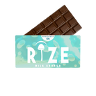 A Rize 12G Mushroom Chocolate Bar peeks from its light blue-green Rize packaging labeled Milk Crunch, with a mushroom graphic and MEGADOSE 12G at the top, suggesting a unique psychedelic experience.