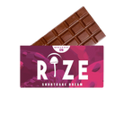 A chocolate bar partially wrapped in a pink and purple package labeled Rize 12G Mushroom Chocolate Bar, featuring a psychedelic mushroom icon—an irresistible treat from Rize.