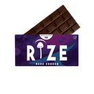 A Rize 12G Mushroom Chocolate Bar is partially unwrapped from a purple and blue wrapper labeled “RIZE Dark Crunch,” featuring a psychedelic mushroom graphic, “MEGADOSE 12G,” and a vegan symbol.