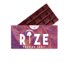 A partially unwrapped Rize 12G Mushroom Chocolate Bar in passion fruit flavor, featuring a purple and orange wrapper with the Rize mushroom icon, “PASSION FRUIT” below, and “MEGADOSE 12G” at the top.