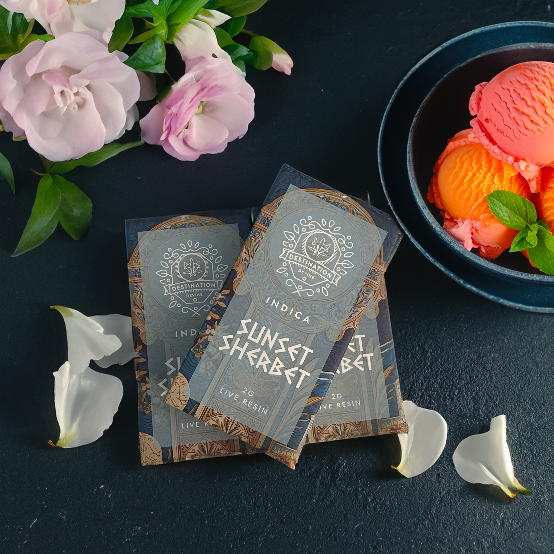 Three Sunset Sherbet live resin chocolate bars sit on a dark surface beside a bowl of orange and pink ice cream, flowers, and leaves—perfect to pair with your favorite deVINE Destinations Live Resin THC Disposable by DeVINE Wellness.