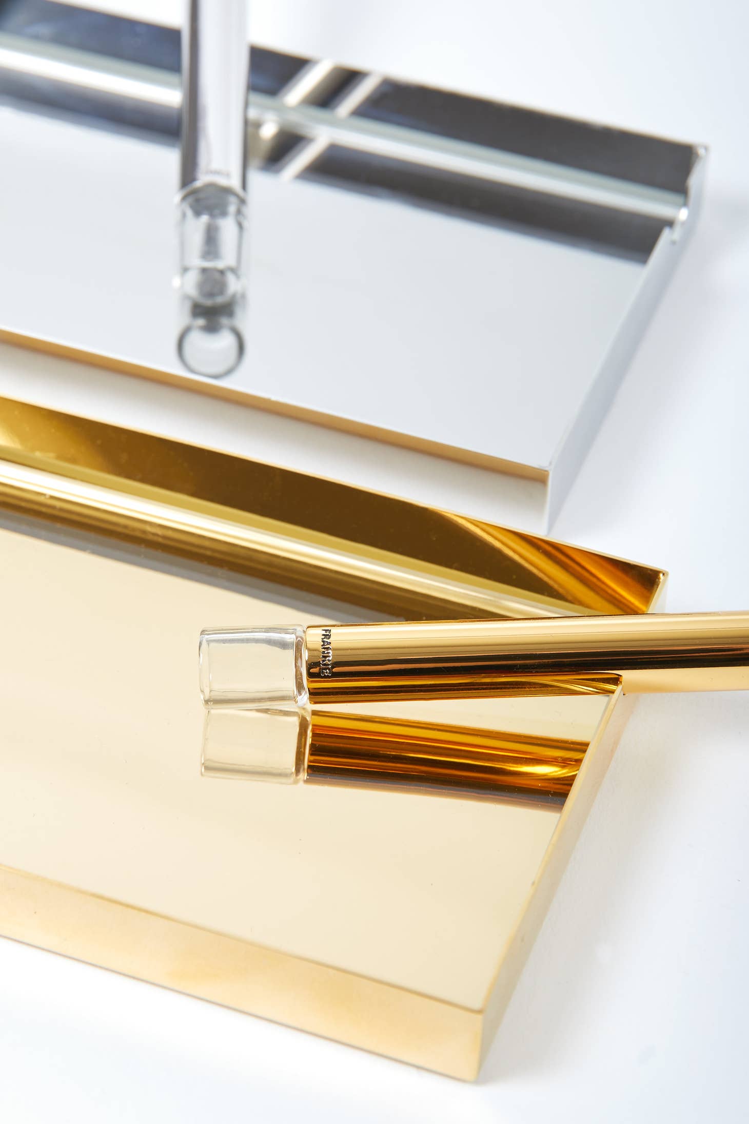 Ashtray + Pipe Set featuring premium gold and silver ashtrays with glass 1-hitter pipe resting on tray edges.