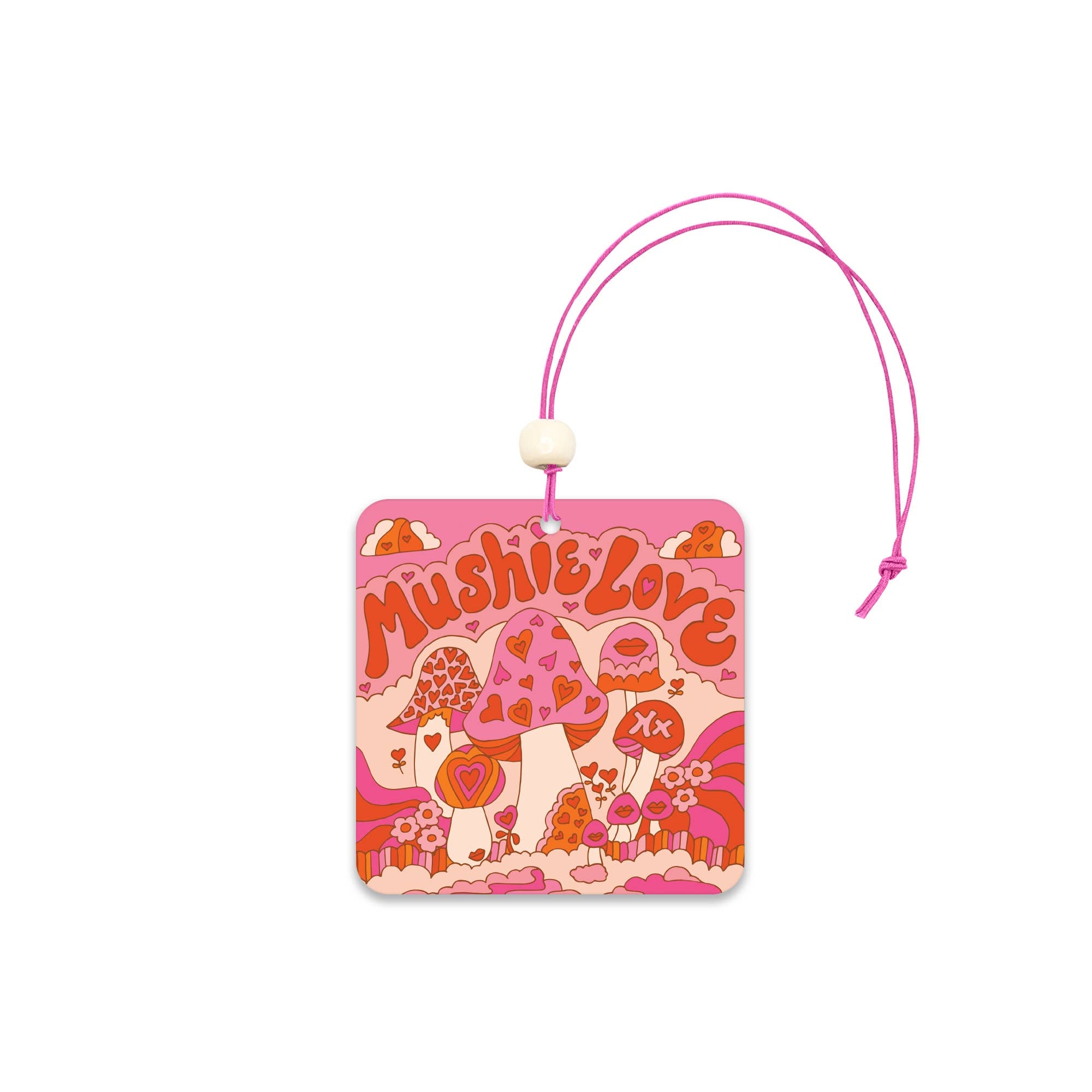 The Mushie Love Car Air Freshener by Studio Oh! features a pink and orange psychedelic mushroom design with hearts, flowers, and a pink string for hanging. It offers long-lasting freshness for your car.