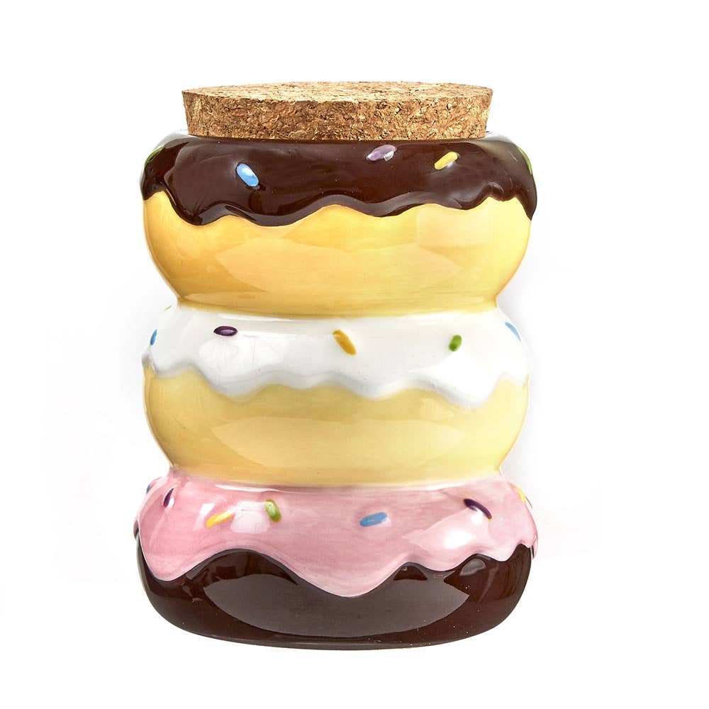 The Donut Stash Jar by Fashioncraft is a ceramic jar shaped like three stacked donuts with chocolate, vanilla, and strawberry icing, colorful sprinkles, and a cork lid—ideal for storing spices or small items.