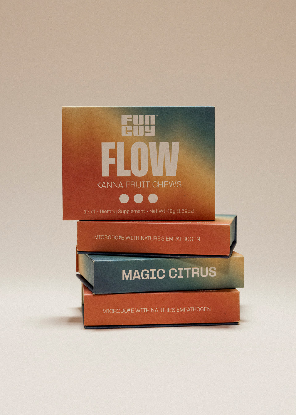Three colorful boxes of Fun Guy Flow Fruit Chews are stacked, with Flow on the top and Magic Citrus below. The packaging shows an orange and blue gradient, highlighting this mood-enhancing supplement.